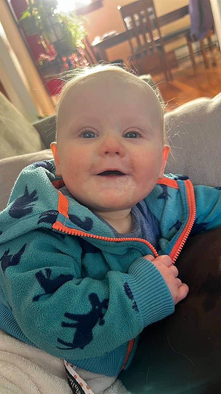 Leo is registered to the contest to win money with this photo: baby, baby_products, baby_safety, baby_toddler_clothing, cheek, child, comfort, eye, facial_expression, fun, happy, laugh, mouth, nose, pattern, person, sitting, skin, sleeve, smile
