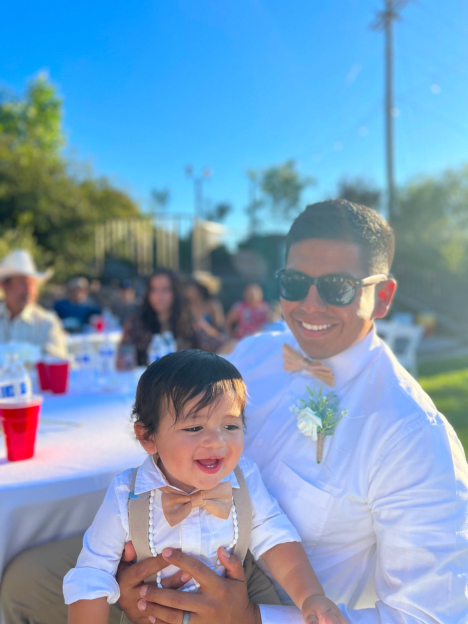 Kayson is registered to the contest to win money with this photo: baby, blue, blurred, child, crowd, event, eyewear, formal_wear, fun, goggles, happy, joy, leisure, person, plant, recreation, sky, smile, sunglasses, toddler
