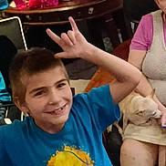 Jason joined the competition — help win amazing prizes! blue_shirt, boy, casual, cat, child, family, furniture, glasses, hand_signs, happy, indoor, man, people, pet, phone, relaxed, seated, short_hair, smile, woman