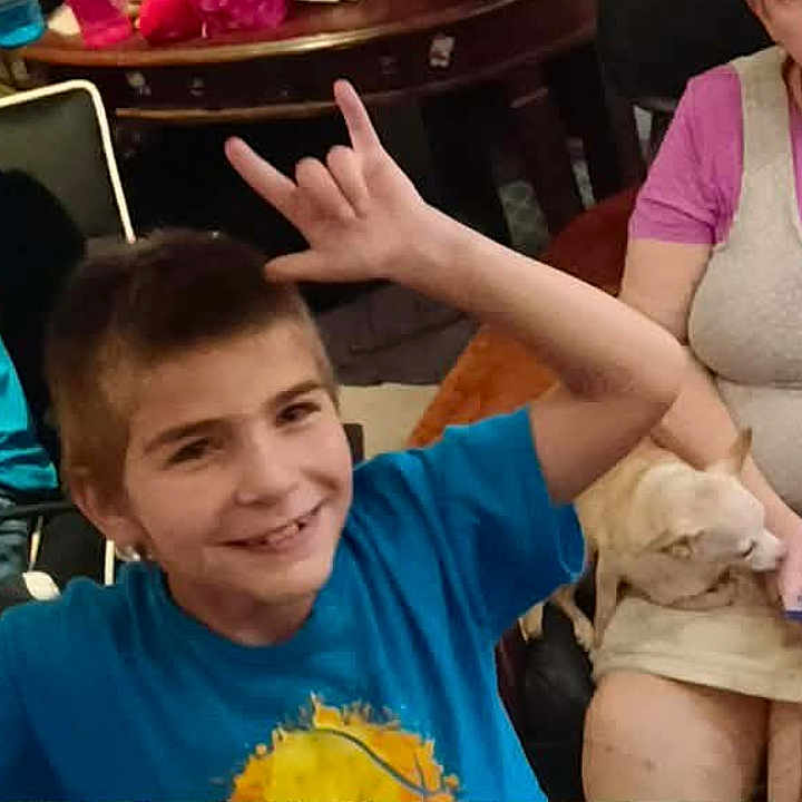 Jason joined the competition — help win amazing prizes! blue_shirt, boy, casual, cat, child, family, furniture, glasses, hand_signs, happy, indoor, man, people, pet, phone, relaxed, seated, short_hair, smile, woman