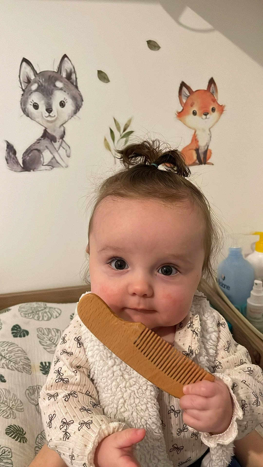 Youna participe au concours pour gagner de l'argent avec cette photo : animal_wall_stickers, baby, baby_girl, child, clothing, comb, curly_hair, cute, expression, face, fox, hand, indoor, infant, patterned_shirt, portrait, soft_lighting, wall_decor, wolf, wooden_comb