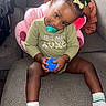 toddler, child, pacifier, toy_ball, couch, socks, hair_clips, green_shirt, plush_toy, cushion, indoor, cute, sitting, portrait, relaxed, smiling, young_child, baby, happy, cozy