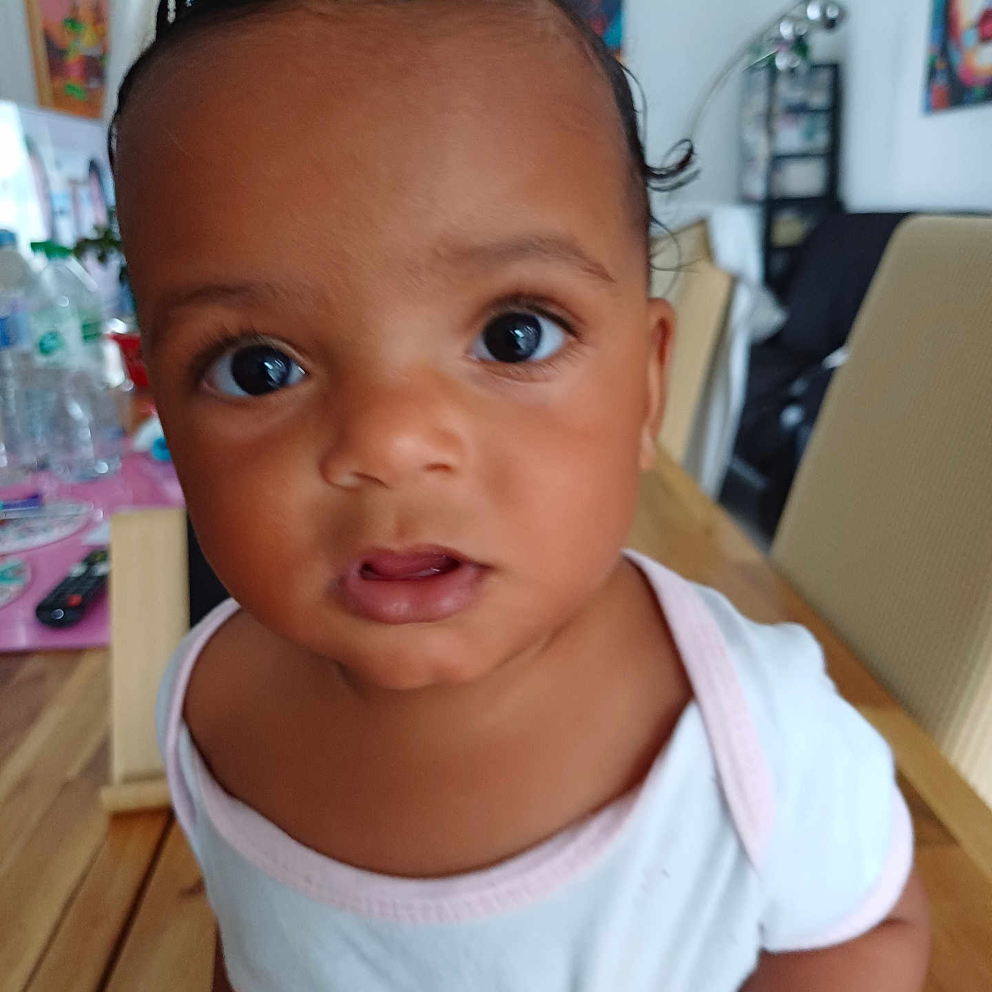 Carla a rejoint le concours — aidez-le/la à gagner de superbes lots ! baby, background, chair, child, colorful, curious, expression, eyes, face, furniture, hair, home, indoor, person, portrait, shirt, skin, table, toddler, wooden_table