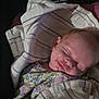 baby, blanket, child, comfort, cozy, cute, face, floral_outfit, indoors, infant, newborn, peaceful, portrait, resting, sleeping, smile, soft, striped_blanket, toddler, wrapped
