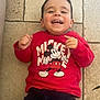 Milo participe au concours pour gagner de l'argent avec cette photo : toddler, child, smiling, happy, red_sweatshirt, mickey_mouse, casual_clothing, indoor, floor, tile, cute, portrait, person, short_hair, laugh, joy, playful, young, face, hands