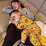 baby, child, clothing, couch, cozy, cushion, cute, family, footwear, happy, indoor, leather, pacifier, pajamas, person, relaxing, siblings, smile, sneakers, toddler