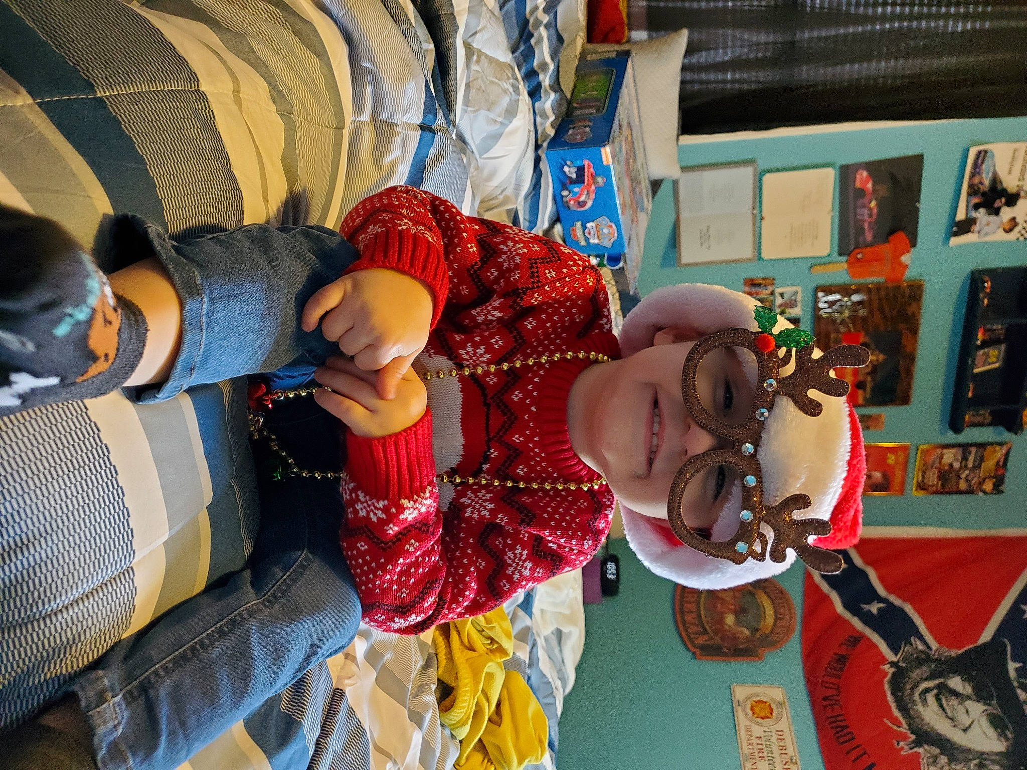 Kaison is registered to the contest to win money with this photo: child, comfort, event, fun, happy, hat, headgear, headwear, holiday, joy, leisure, pattern, person, picture_frame, product, room, smile, toddler, toy, tradition