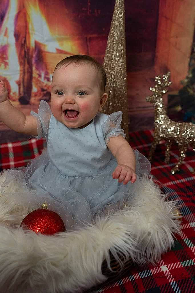 Christina is registered to the contest to win money with this photo: baby, christmas, christmas_decoration, christmas_eve, christmas_ornament, christmas_tree, event, flash_photography, fun, fur, happy, holiday, holiday_ornament, ornament, person, red, smile, standing, toddler, tradition