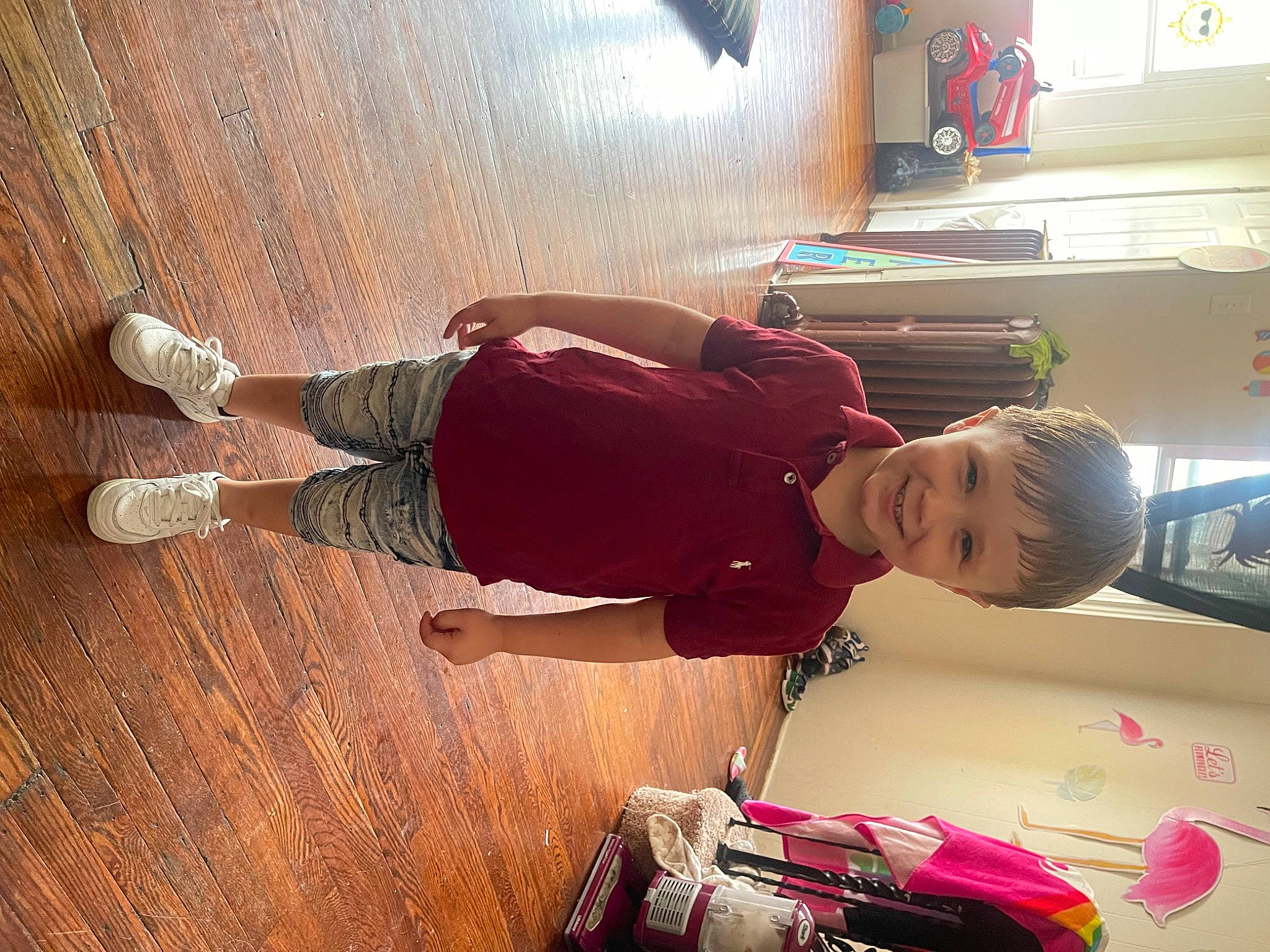 Jeremy is registered to the contest to win money with this photo: baby_toddler_clothing, bag, carmine, child, cool, elbow, flooring, fun, happy, hardwood, joy, luggage_and_bags, person, play, room, snapshot, standing, t_shirt, toddler, varnish