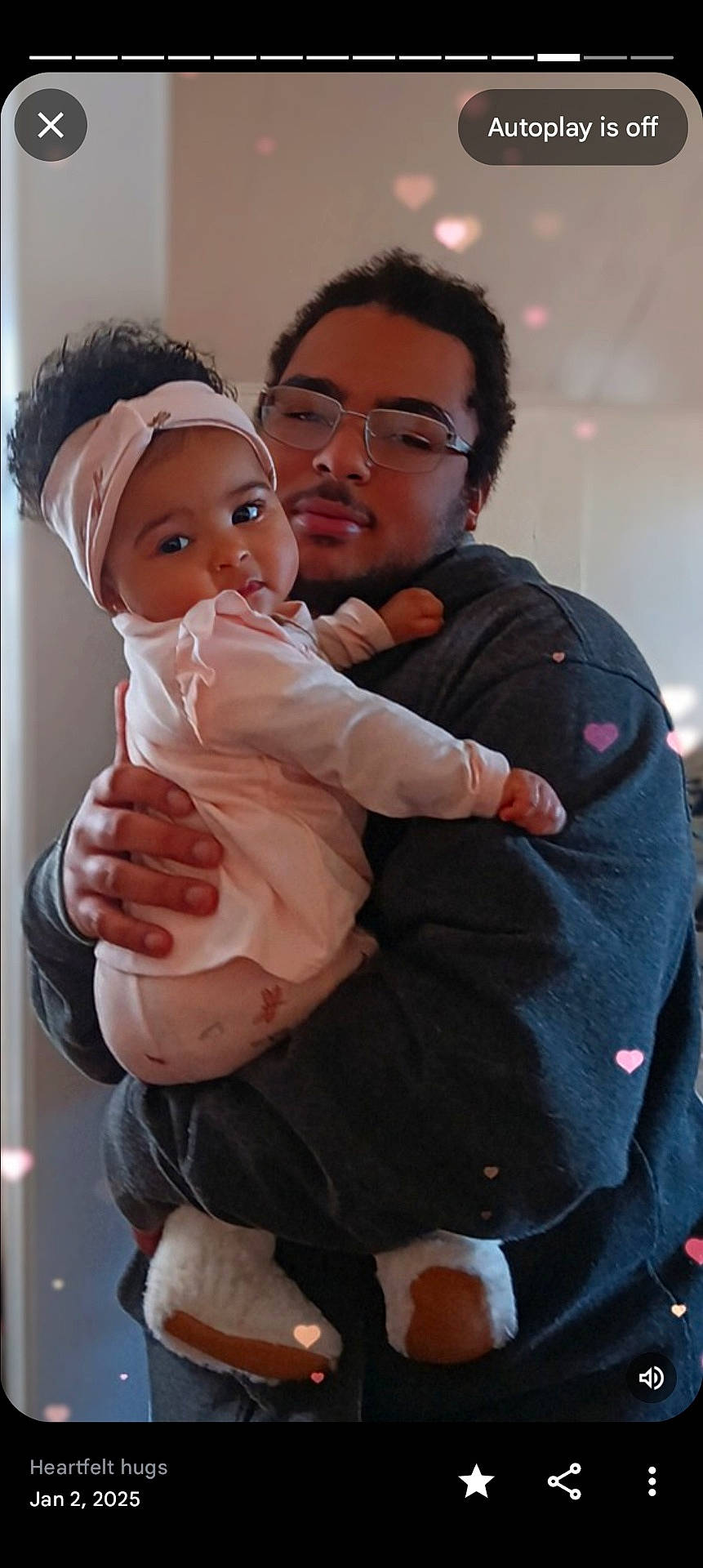 adult, affection, baby, casual_clothing, cozy, curly_hair, facial_hair, family, footwear, glasses, hand, headband, hearts, hug, indoor, love, pink_clothing, portrait, smile, warmth