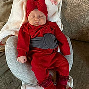 Ruby joined the competition — help win amazing prizes! baby, sleeping, red_clothing, headband, bow, socks, blanket, cushion, sofa, indoors, infant, cute, peaceful, comfort, child, person, soft_fabric, rest, wearing, relaxation