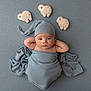 baby, infant, blanket, hat, soft_toys, sheep, blue, wrapped, lying_down, hands_behind_head, cozy, cute, portrait, child, sleepy, nursery, fabric, plush, peaceful, studio