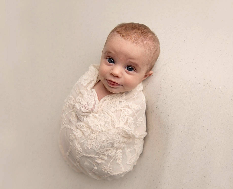 Catherine is registered to the contest to win money with this photo: baby, beige, cheek, child, eye, face, fur, head, neck, outerwear, person, photography, portrait, sitting, skin, sleeve, textile, toddler, white
