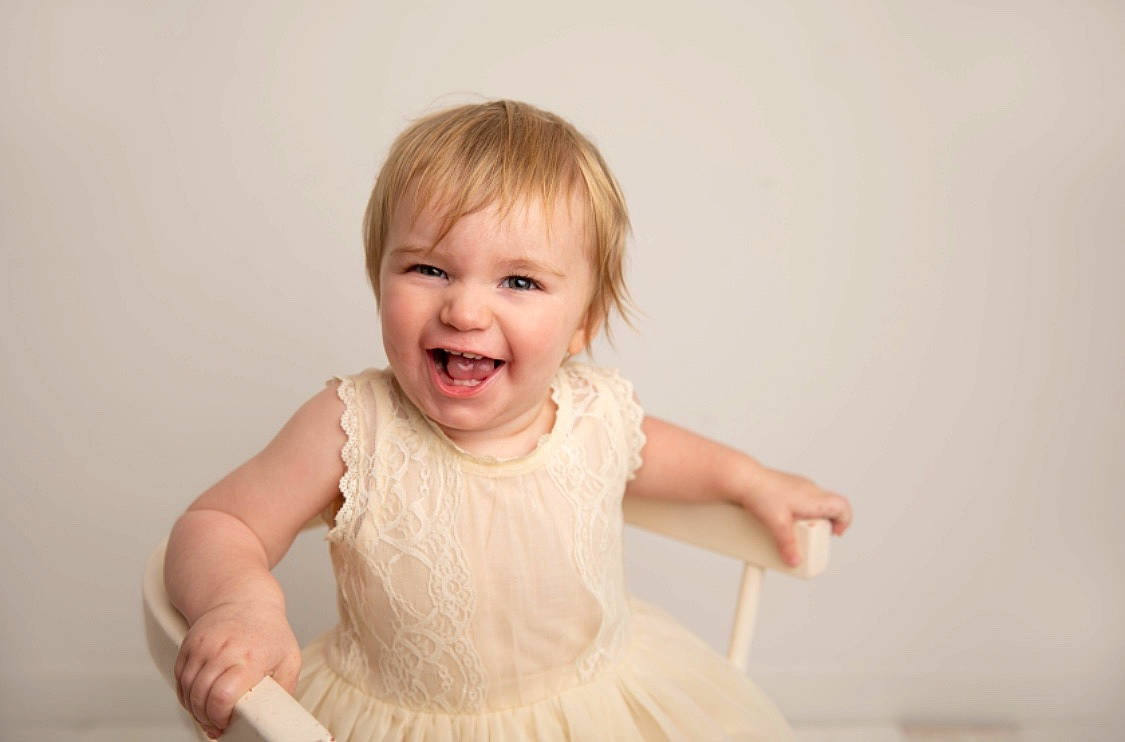 Lillie-rose is registered to the contest to win money with this photo: arm, baby, blond, cheek, child, face, facial_expression, finger, hand, happy, head, joy, nose, person, photograph, photography, pink, skin, smile, standing