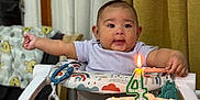 Solana is registered to the contest to win money with this photo: baby, infant, birthday_cake, candle, 4_months, high_chair, toy, celebration, milestone, sprinkles, colorful, indoor, curtain, table, smiling, person, clothing, cute, happy, child