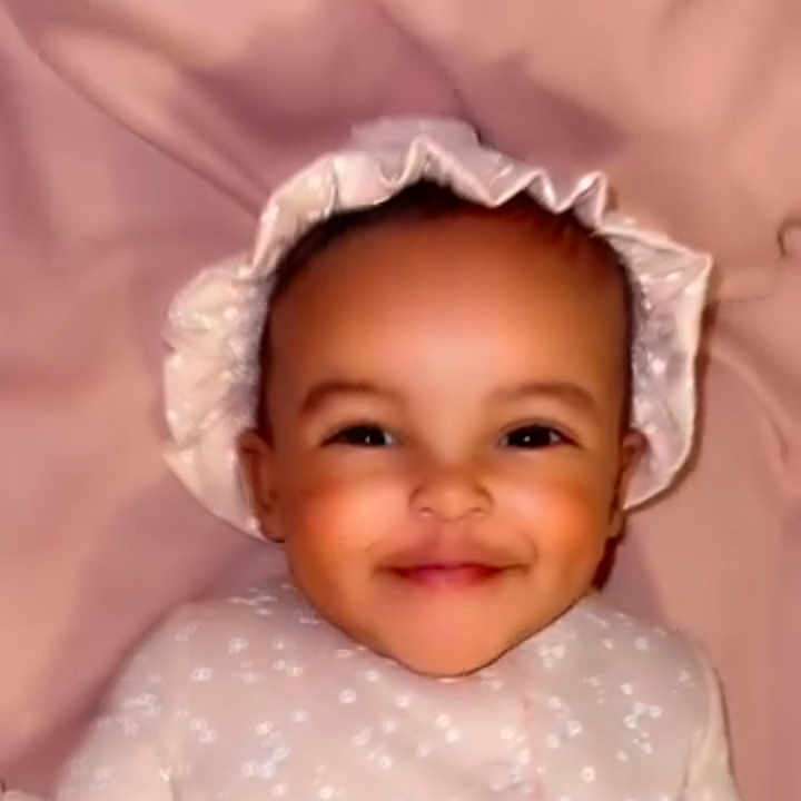 Noelauni is registered to the contest to win money with this photo: adorable, baby, bonnet, child, closeup, clothing, cozy, cute, face, happy, headwear, indoors, infancy, infant, lying_down, pink_blanket, portrait, smiling, soft_lighting, young_child