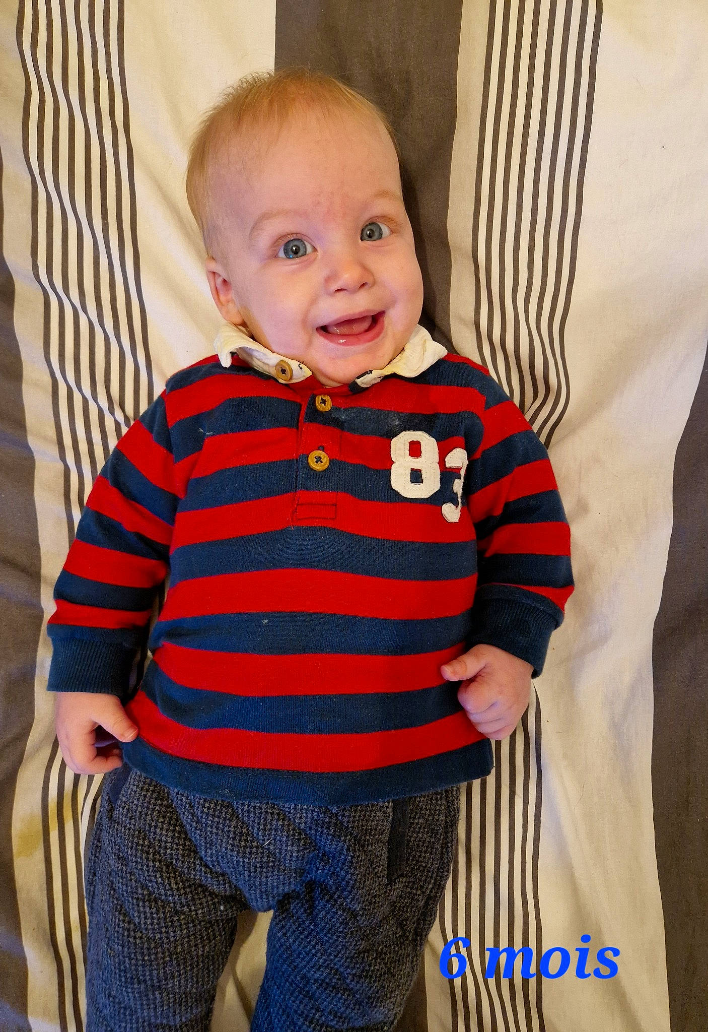 Mattheo participe au concours pour gagner de l'argent avec cette photo : baby, baby_toddler_clothing, cheek, child, clothing, collar, comfort, curtain, electric_blue, eye, face, flooring, happy, human_body, pattern, person, sleeve, smile, t_shirt, toddler