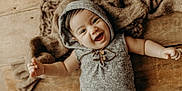 Lorenzo joined the competition — help win amazing prizes! arm, baby, baby_boy, baby_girl, blanket, child, cozy, cute, expression, gray_clothing, happy, headwear, hoodie, indoors, infant, portrait, smiling, texture, wooden_floor, young_child
