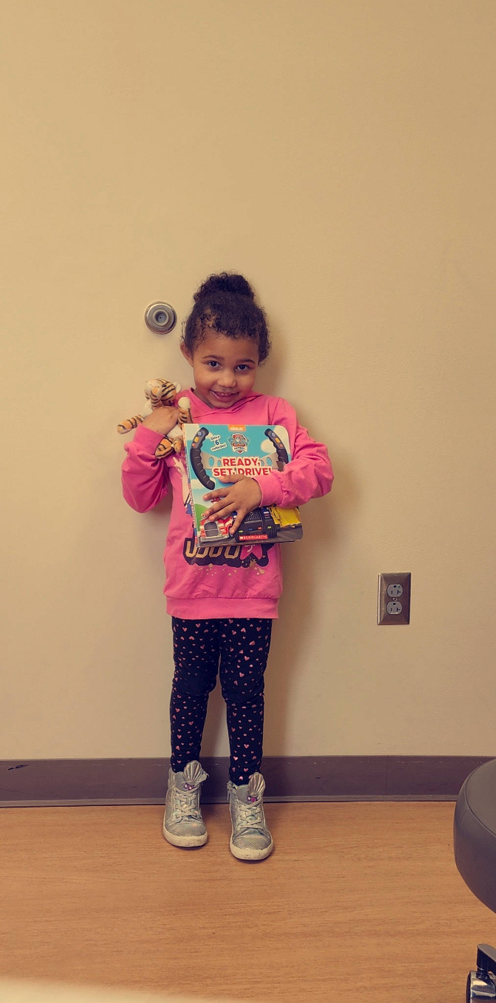 Aiyanna is registered to the contest to win money with this photo: baby_toddler_clothing, balloon, child, clothing, face, fashion_design, flooring, hair, happy, head, joy, leg, magenta, neck, pattern, person, pink, purple, sleeve, smile