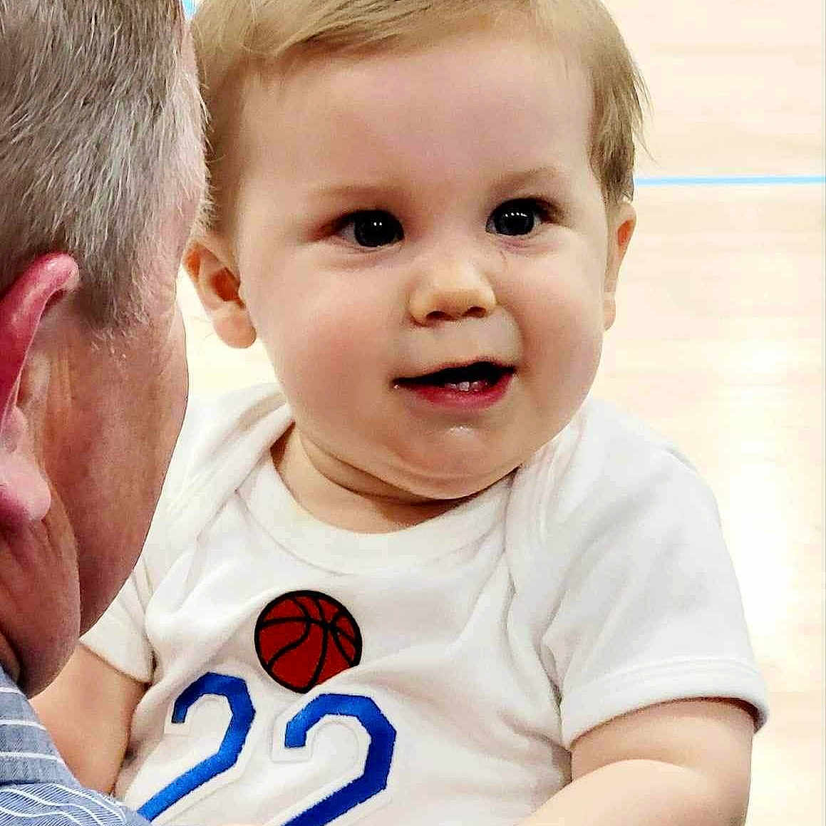 Riley is registered to the contest to win money with this photo: baby, blonde, bodypart, clothing, face, finger, frown, hair, hand, happy, head, pants, people, person, photography, portrait, sad, shirt, smile, t_shirt