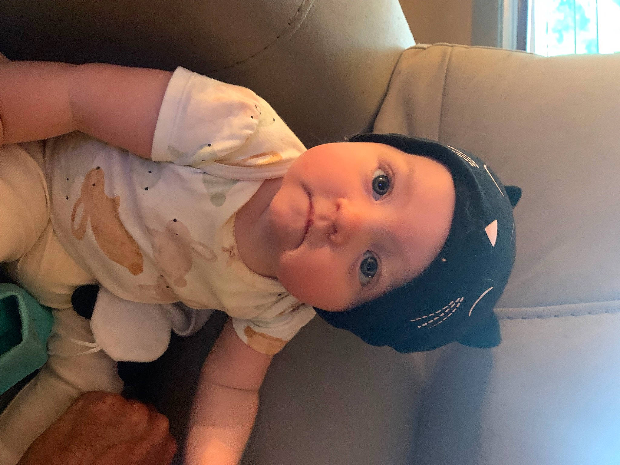 Isobel is registered to the contest to win money with this photo: baby, baby_toddler_clothing, cheek, chest, child, chin, comfort, elbow, eye, eyelash, face, hat, headwear, lip, mouth, nose, person, skin, sleeve, smile