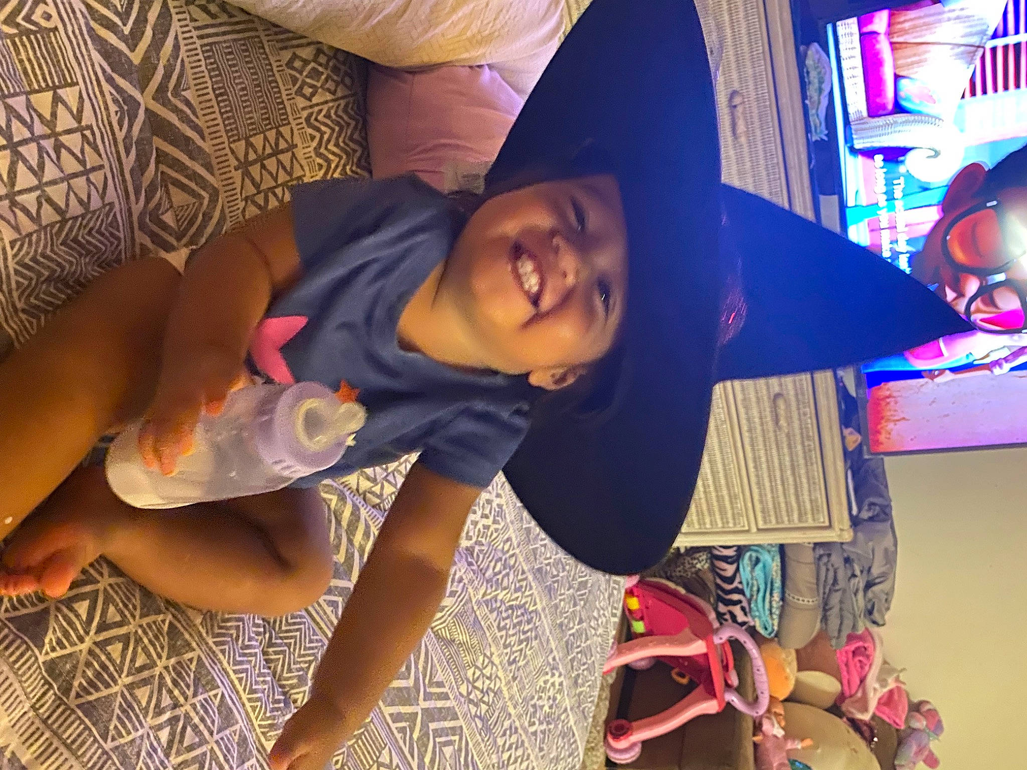Luna Rose is registered to the contest to win money with this photo: child, cool, fashion_accessory, flooring, foot, fun, happy, hat, headwear, human_leg, joy, leisure, magenta, mouth, person, pink, purple, room, smile, t_shirt
