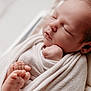 Lyo participe au concours pour gagner de l'argent avec cette photo : newborn, baby, sleeping, wrapped, blanket, soft, feet, fist, peaceful, closeup, portrait, infant, cute, skin, cozy, resting, child, indoors, warm, calm