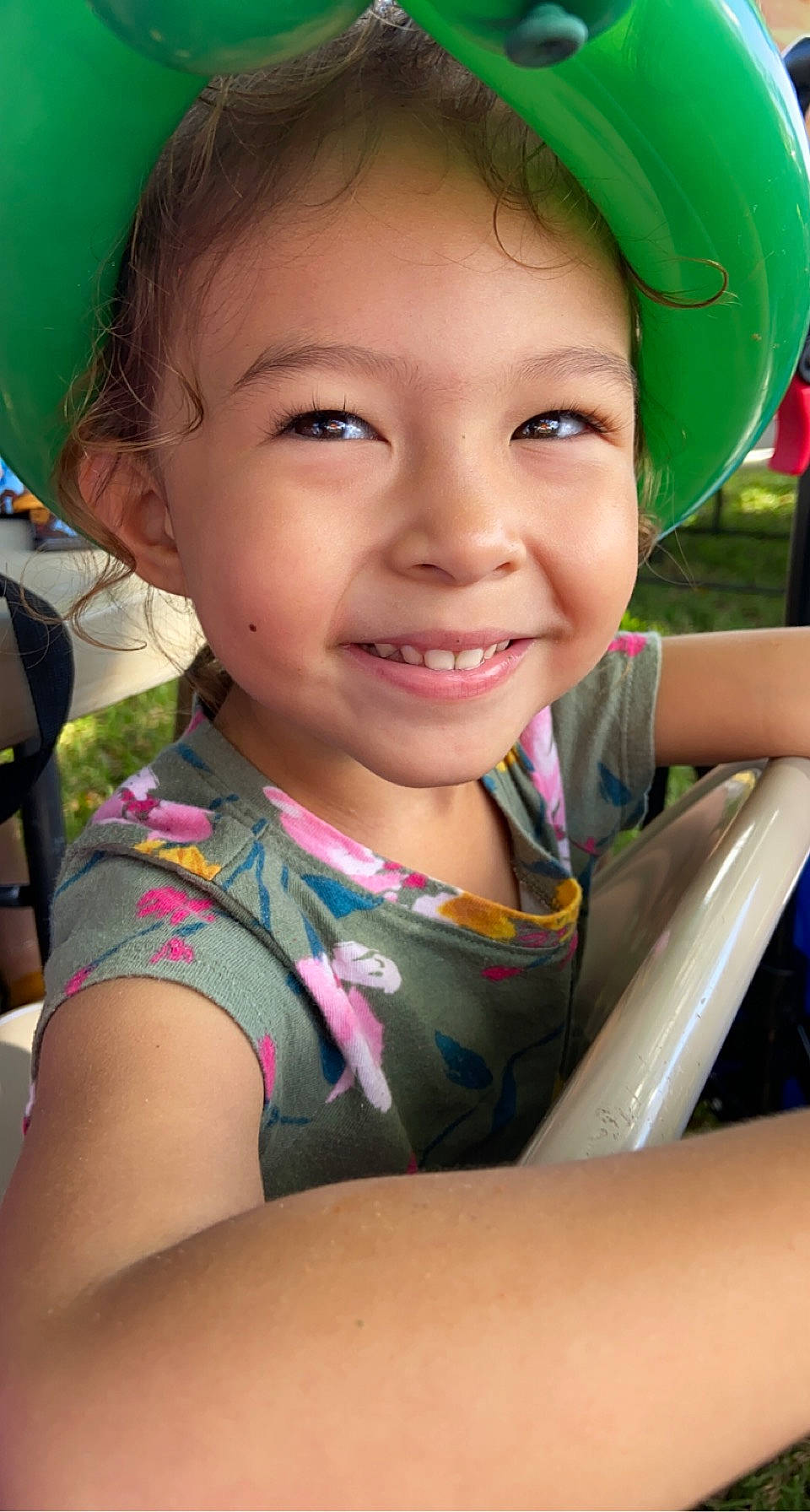 Avery is registered to the contest to win money with this photo: chin, cool, eye, face, facial_expression, fun, grass, green, happy, head, human_body, joy, leisure, lip, mouth, nose, organ, person, pink, skin