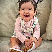Alizeth is registered to the contest to win money with this photo: baby, child, clothing, couch, cozy, cute, face, hands, happy, indoor, infant, outfit, person, pigtails, pink, portrait, seated, shoes, smiling, socks