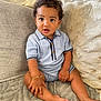 Dejai joined the competition — help win amazing prizes! baby, beige, blue_outfit, bracelet, child, couch, cozy, curly_hair, cute, foot, furniture, hand, indoor, looking_at_camera, person, portrait, sitting, skin, smiling, toddler