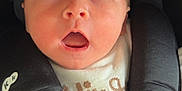 Gracie-Leigh is registered to the contest to win money with this photo: baby, infant, car_seat, sweater, child, face, expression, open_mouth, cute, curious, seatbelt, clothing, closeup, head, portrait, indoors, soft_lighting, skin, baby_hand, young_child
