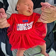 Gracie-Leigh joined the competition — help win amazing prizes! baby, sleeping, red_dress, infant, adult_hands, holding, close_up, cute, peaceful, newborn, tulle_skirt, person, portrait, soft_lighting, indoor, family, love, tenderness, skin, clothing