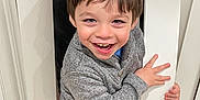 Julian joined the competition — help win amazing prizes! bodypart, boy, brownhair, child, clothing, door, face, finger, hair, hand, happy, head, hiding, jeans, male, pants, person, photography, portrait, smile