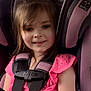 child, car_seat, pink_clothing, smiling, seat_belt, girl, hair_bow, plaid_skirt, child_safety, interior, vehicle, cute, happy, portrait, young_child, seat, car, child_in_car, secure, casual_clothing