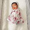 Kingsley joined the competition — help win amazing prizes! newborn, baby, swaddled, blanket, crib, sleeping, infant, patterned, floral, star_pattern, face, head, peaceful, resting, indoors, child, cute, person, bed, soft
