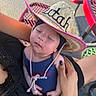 Kingsley joined the competition — help win amazing prizes! baby, hat, straw_hat, texas, child, person, hand, nails, purple_nails, polka_dot, blue_clothing, outdoor, picnic_table, red_table, metal_table, seating, sunlight, relaxing, cradling, closeup