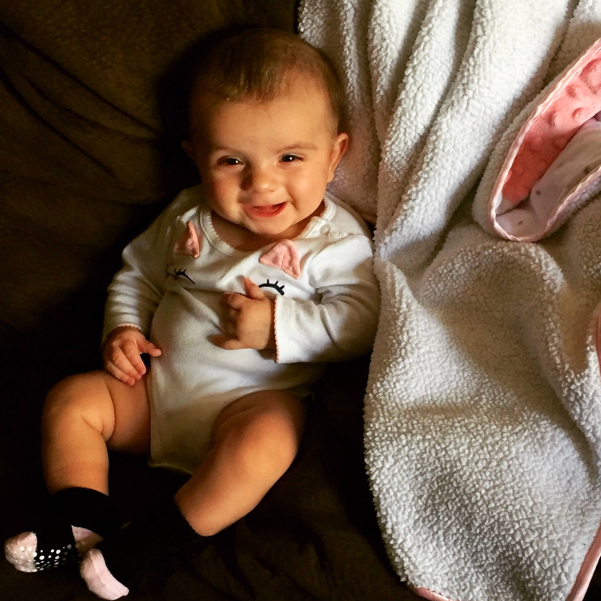 Isabelle is registered to the contest to win money with this photo: baby, cheek, child, comfort, finger, hand, joy, person, product, sitting, skin, smile, toddler