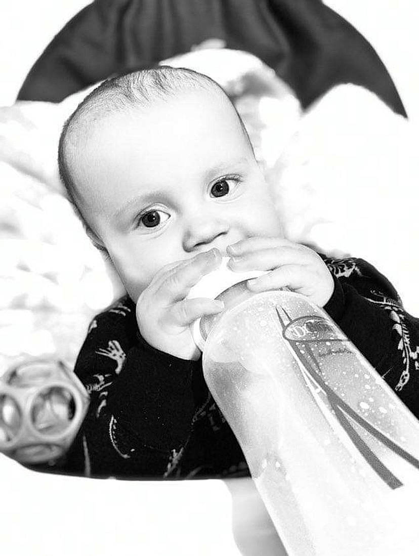 Greyson is registered to the contest to win money with this photo: baby, baby_toddler_clothing, black_and_white, cheek, child, drinkware, eye, eyebrow, flash_photography, gesture, happy, human, iris, lip, monochrome, monochrome_photography, person, skin, sleeve, style