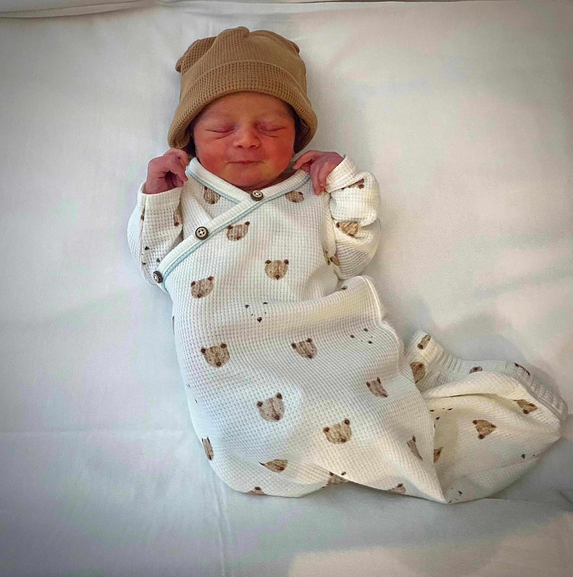 Phoenix joined the competition — help win amazing prizes! newborn, baby, infant, sleeping, hat, blanket, white, brown, bear_pattern, clothing, cozy, cute, resting, portrait, child, soft_texture, wrapped, small_hands, peaceful, indoors