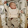 baby, sleeping, infant, cozy, blanket, baby_nest, animal_print, clothing, bib, socks, soft_toys, peaceful, indoors, cute, resting, portrait, newborn, comfortable, nursery, child