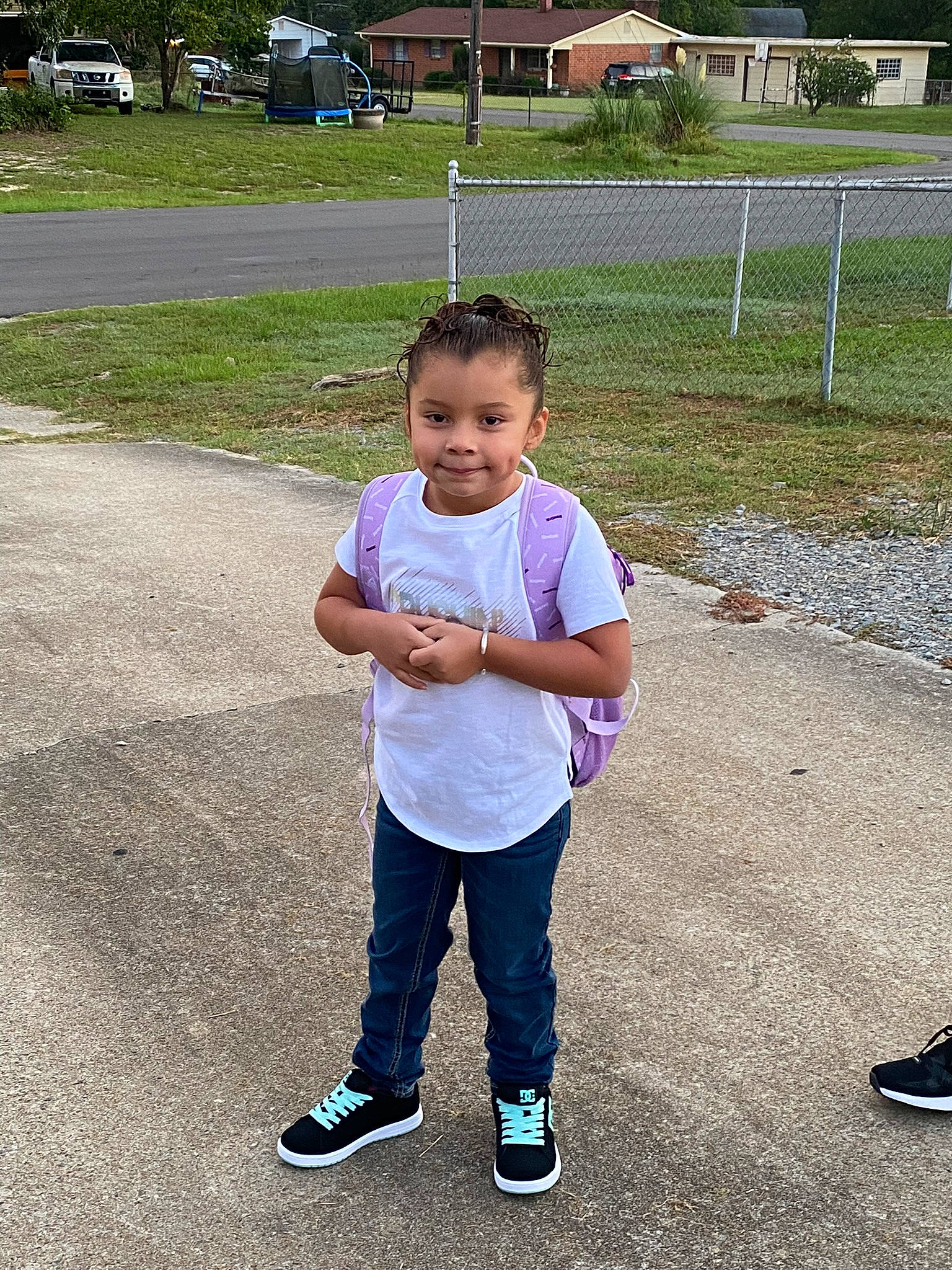 Felicity is registered to the contest to win money with this photo: asphalt, child, footwear, fun, gesture, grass, happy, joy, leisure, people_in_nature, person, plant, play, recreation, road, road_surface, shoe, sleeve, sneakers, toddler