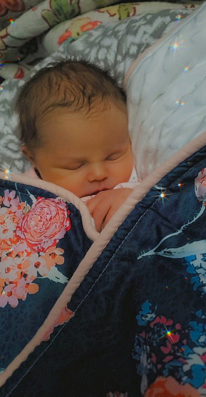 Addalynn is registered to the contest to win money with this photo: baby, baby_toddler_clothing, bedtime, cheek, child, comfort, eyebrow, fur, iris, linens, lip, nose, pattern, peach, person, petal, pink, skin, sleeve, textile