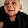 Tony is registered to the contest to win money with this photo: baby, child, face, smile, eyes, portrait, black_clothing, closeup, infant, happy, skin, head, expression, person, indoors, cute, young, human, baby_girl, baby_boy