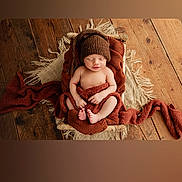 Charlie joined the competition — help win amazing prizes! newborn, baby, sleeping, basket, knitted_hat, brown_blanket, wooden_floor, cozy, wrapped, infant, peaceful, soft_texture, indoors, portrait, sleep, child, warm_colors, cute, resting, blanket