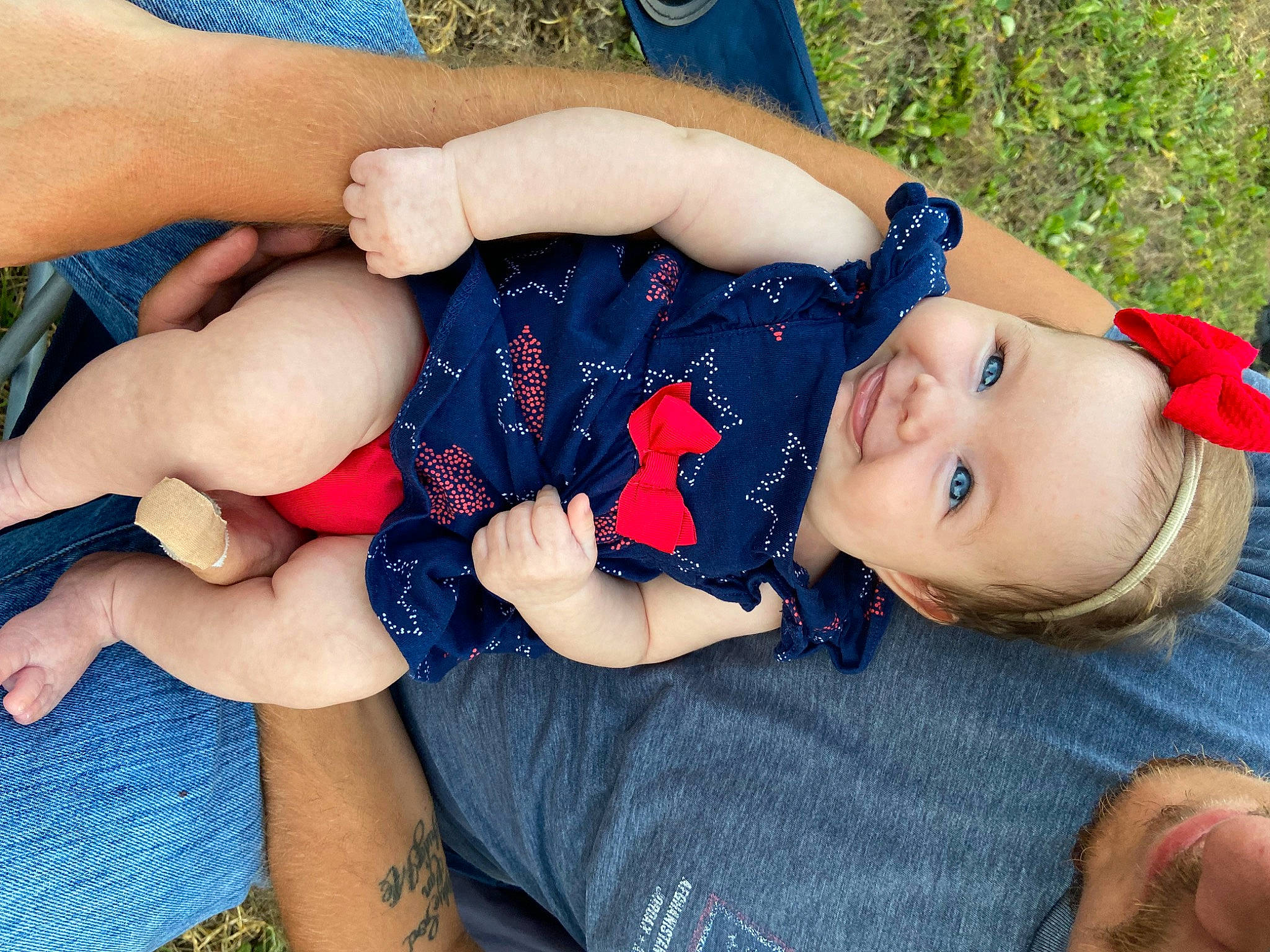 Bonnie Ann is registered to the contest to win money with this photo: baby_toddler_clothing, blue, electric_blue, eye, finger, gesture, grass, hand, happy, head, headgear, human_body, knee, person, plant, skin, thigh, toddler, tree, trunk