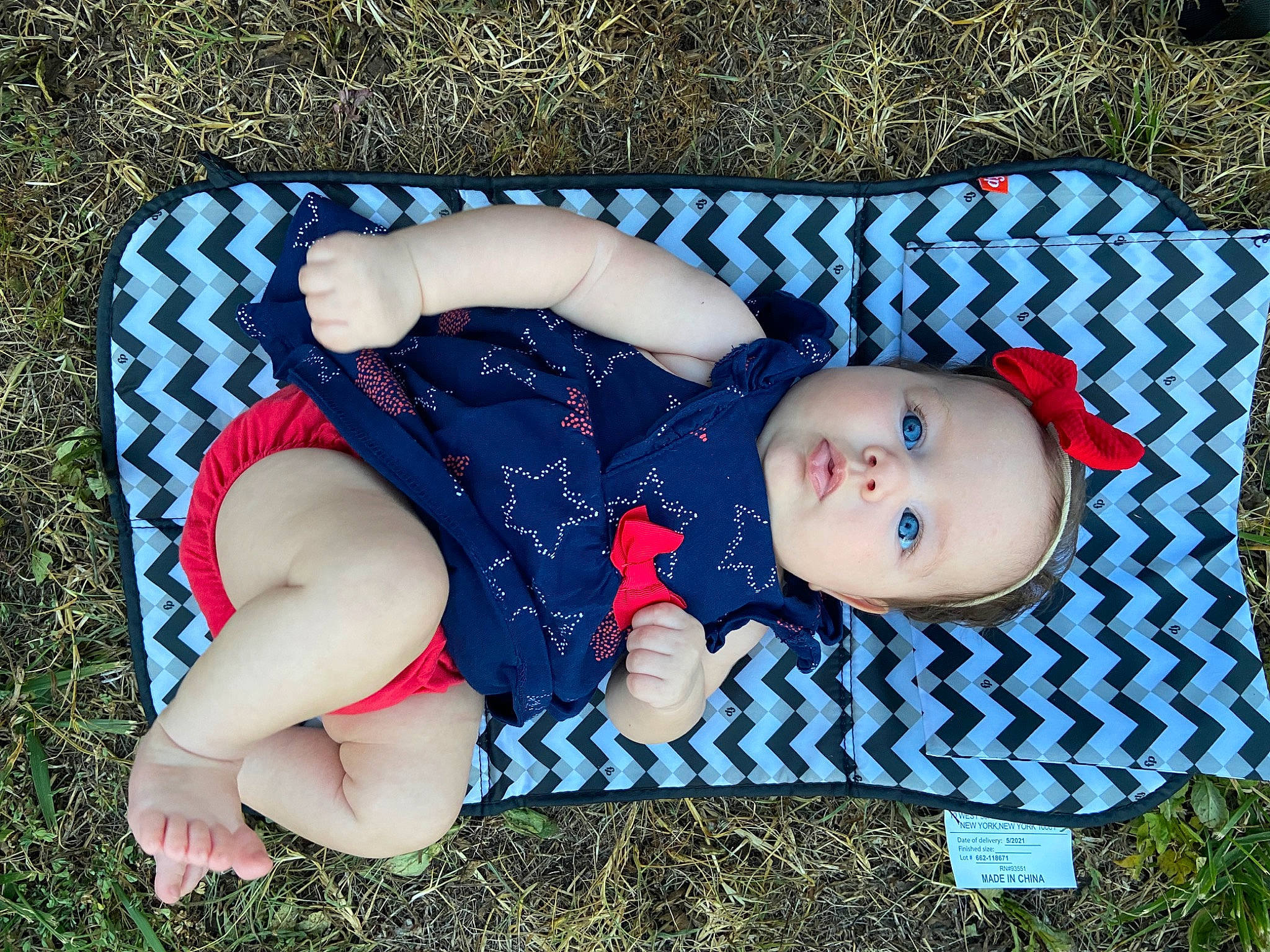 Bonnie Ann joined the competition — help win amazing prizes! baby, baby_products, baby_toddler_clothing, carmine, child, electric_blue, fashion_accessory, fun, grass, happy, hat, headgear, human_leg, leaf, pattern, people_in_nature, person, sitting, textile, thigh