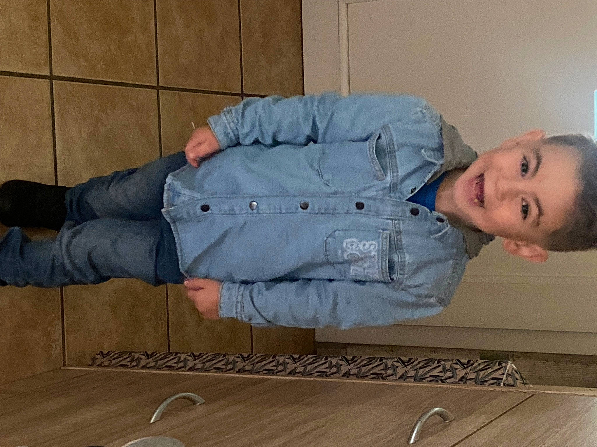 Tyson a rejoint le concours — aidez-le/la à gagner de superbes lots ! baby_toddler_clothing, clothing, comfort, denim, elbow, flooring, hardwood, human_leg, jeans, joint, knee, person, sitting, sleeve, smile, thigh, toddler, varnish, wood, wood_flooring