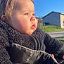 child, toddler, baby, face, cheeks, blue_eyes, profile, side_view, sunlight, outdoors, blue_sky, house, building, stroller, jacket, fleece, winter_clothing, portrait, closeup, peaceful