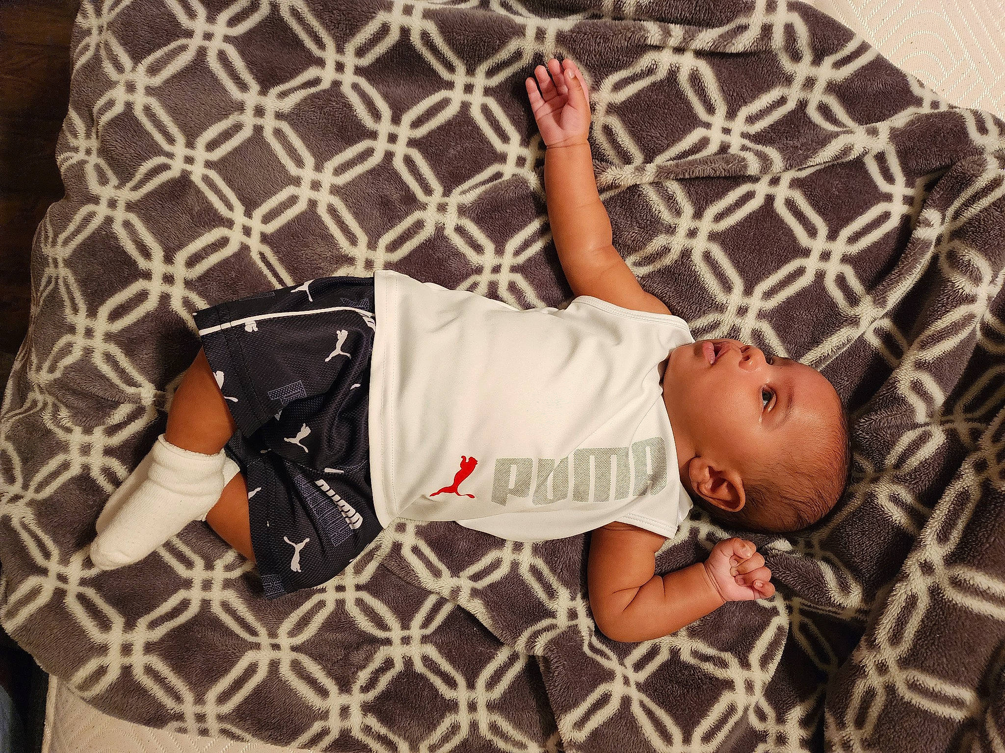 Angelo is registered to the contest to win money with this photo: abdomen, arm, baby, baby_products, baby_sleeping, baby_toddler_clothing, child, comfort, human_body, human_leg, leg, linens, pattern, person, room, sitting, sleeve, textile, thigh, toddler