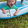Colin joined the competition — help win amazing prizes! toddler, child, pool, inflatable, water, grass, happy, laughing, outdoor, summer, toy, person, playing, wet, green, fun, small_pool, adult_legs, splash, daytime
